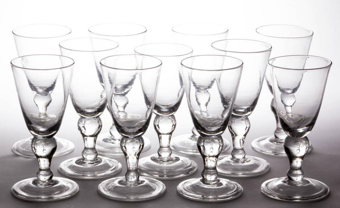 FREE-BLOWN GLASS GOBLETS, LOT OF 11: FREE-BLOWN GLASS GOBLETS, LOT OF 11, colorless lead glass, each having a pointed round funnel bowl raised on an inverted baluster-form stem and circular foot with a folded-over edge, rough pontil mark