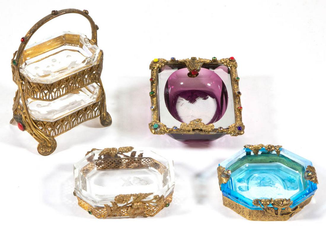 INTAGLIO GLASS OPEN SALTS, LOT OF FOUR: INTAGLIO GLASS OPEN SALTS, LOT OF FOUR, colorless, deep amethyst, and blue, comprising two stacked examples in a filigree frame with two boys playing with a ball to each base, one having a harbor and 
