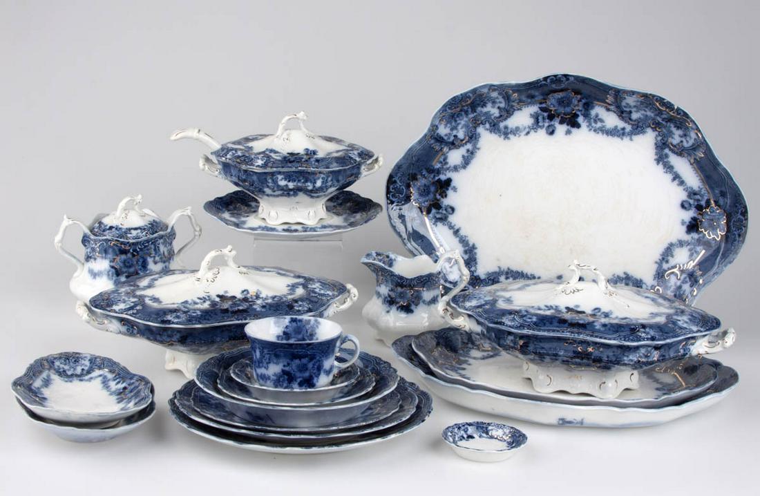 ENGLISH STAFFORDSHIRE FLOW BLUE "GLENWOOD" CERAMIC: ENGLISH STAFFORDSHIRE FLOW BLUE "GLENWOOD" CERAMIC PARTIAL DINNER SERVICE, LOT OF 95, each featuring blue floral and swag motifs with gilt accents, including a covered sugar, a creamer, nine cup and s