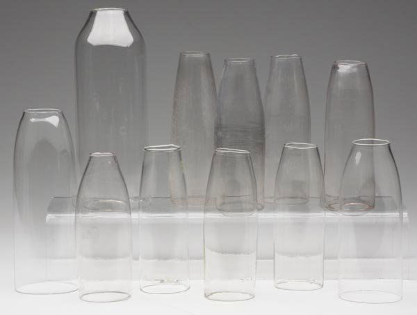VARIOUS CYLINDER CHIMNEYS, LOT OF TEN: VARIOUS CYLINDER CHIMNEYS, LOT OF TEN, colorless. Together with a Pyrex example. Eleven pieces total. 5 5/8" to 8" h, 2" to 2 7/8" dia bases.Provenance: From a Connecticut private collection.