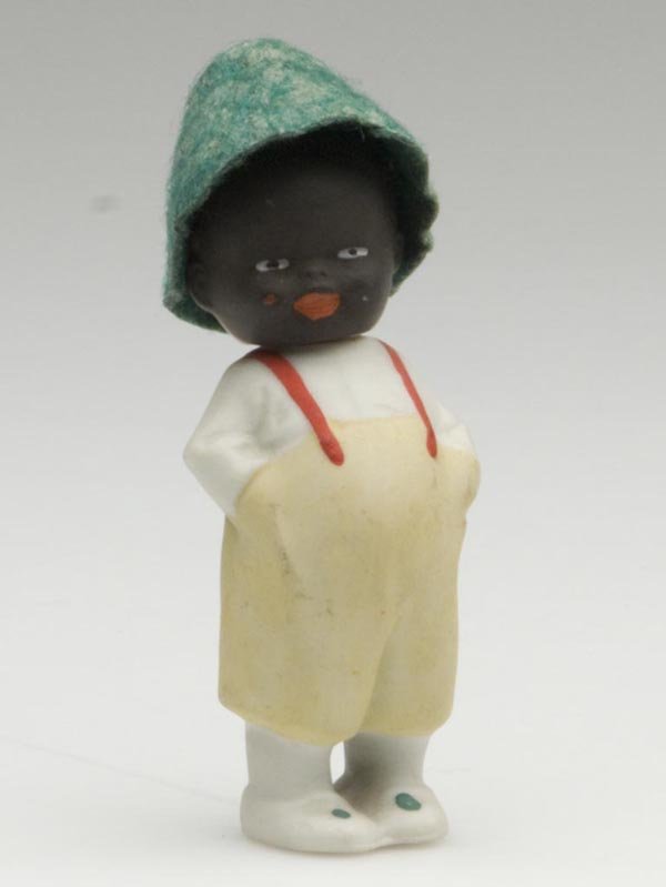 BLACK AMERICANA GERMAN BISQUE TWO-FACE DOLL: BLACK AMERICANA GERMAN BISQUE TWO-FACE DOLL, polychrome decoration, head swivels to reveal white face, original felt hat, impressed "Germany" on reverse. First half 20th century. 3 1/4" h overall. Pro