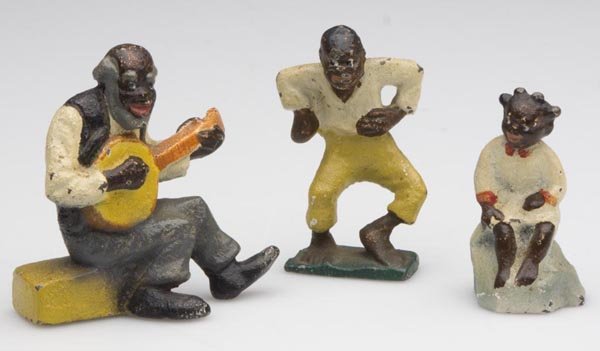 BLACK AMERICANA CAST IRON FIGURES, LOT OF THREE: BLACK AMERICANA CAST IRON FIGURES, LOT OF THREE, polychrome decoration, consisting of a seated older man playing the banjo, a boy dancing and a seated little girl. 20th century. 2" to 2 3/8" h. Proven