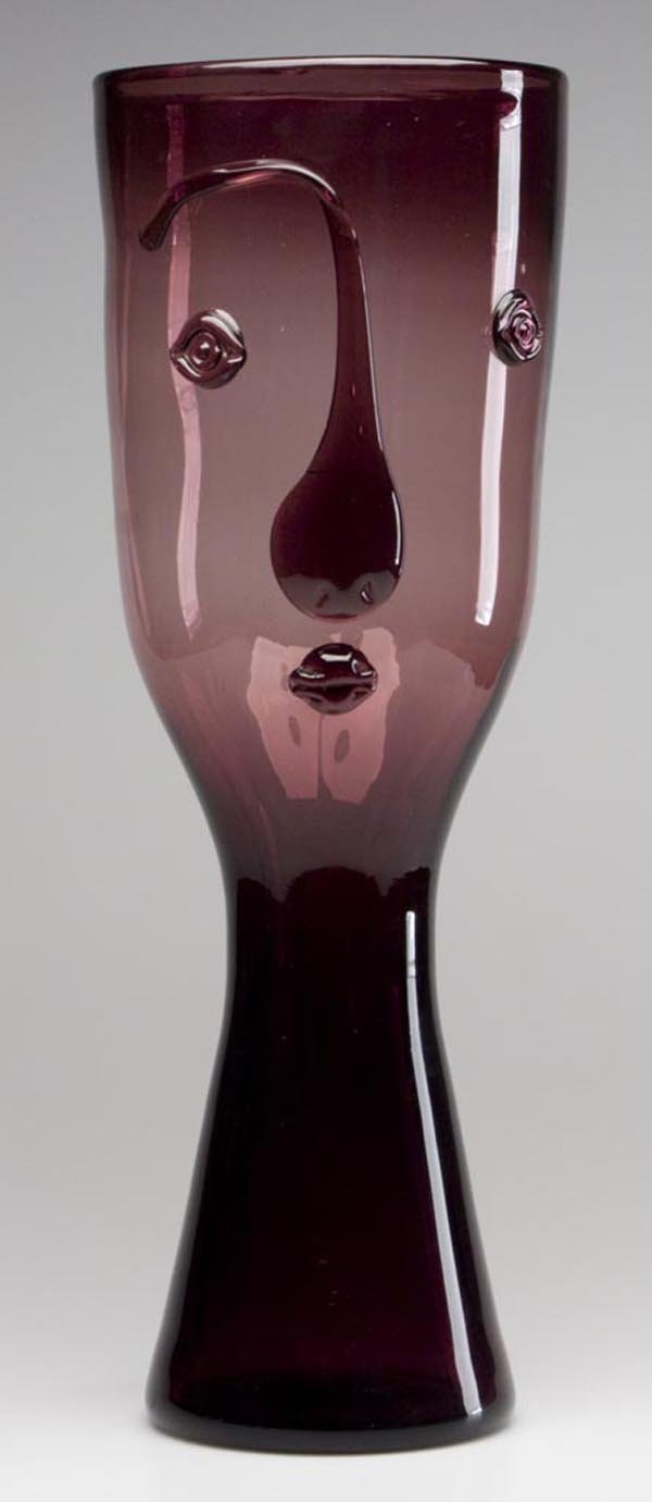 BLENKO GLASS - WAYNE HUSTED DESIGN #552 PORTRAIT V: BLENKO GLASS - WAYNE HUSTED DESIGN #552 PORTRAIT VASE, amethyst, applied facial features, rough pontil mark. Mid 20th century. 20 3/4" h, 7" dia overall. Provenance: From a private New York State coll
