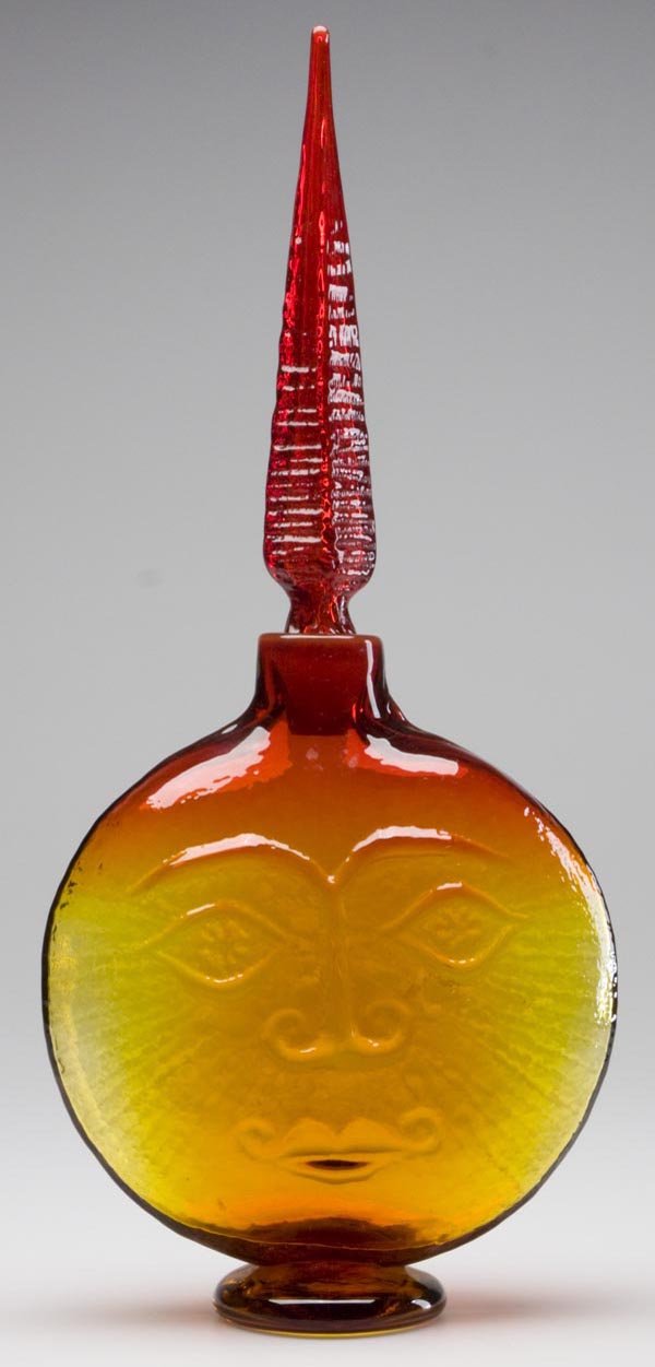 BLENKO GLASS - WAYNE HUSTED DESIGN #6218 OMNIBUS /: BLENKO GLASS - WAYNE HUSTED DESIGN #6218 OMNIBUS / SUN FACE DECANTER, Tangerine, spire stopper, rough pontil mark. Mid 20th century. 20 3/4" h, 7" dia overall.