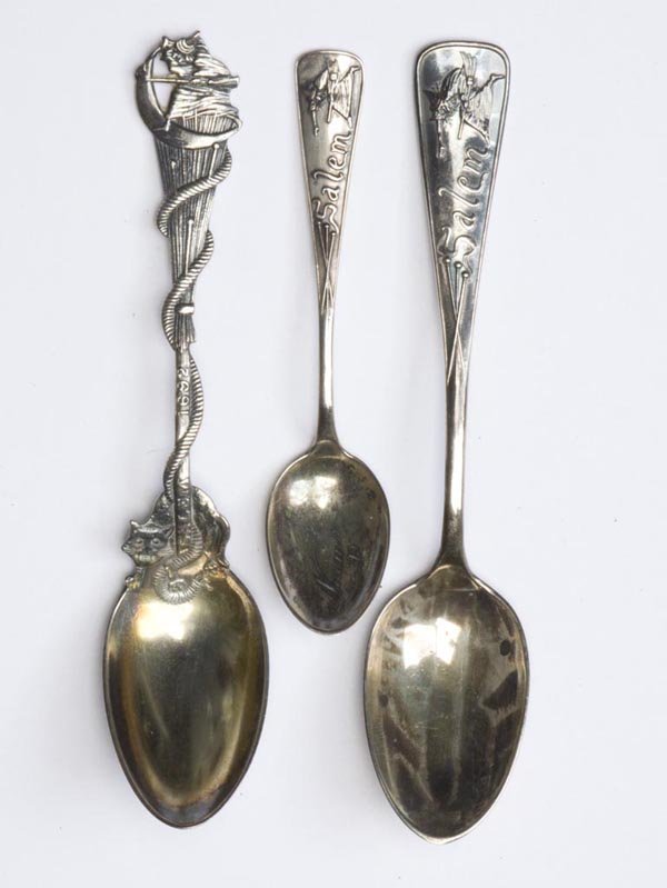 STERLING SILVER SALEM WITCH SOUVENIR SPOONS, LOT O: STERLING SILVER SALEM WITCH SOUVENIR SPOONS, LOT OF THREE, consisting of a large and small example of one design and another with a witch and cat on the handle, each marked for Daniel Lowe. 2.26 ozt. 