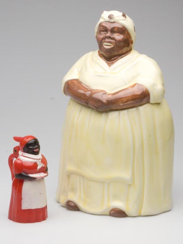 BLACK AMERICANA MAMMY ARTICLES, LOT OF TWO: BLACK AMERICANA MAMMY ARTICLES, LOT OF TWO, consisting of a Mosaic Tile Co. yellow Mammy cookie jar and a F. & F. Mold & Die Works red plastic Aunt Jemima syrup with black and white cold paint. Mid 20