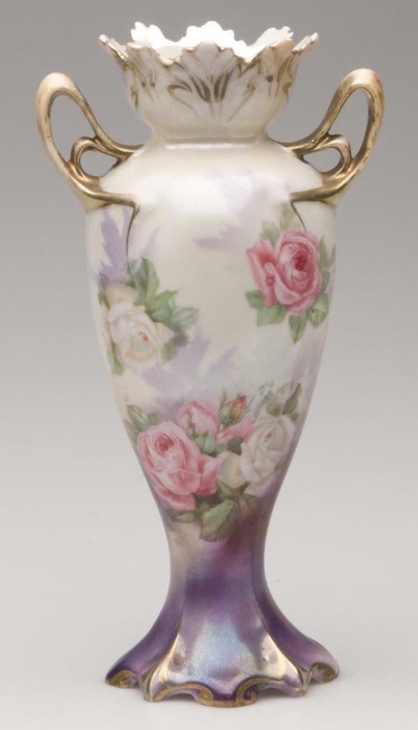 R. S. PRUSSIA TIFFANY FINISH VASE: R. S. PRUSSIA TIFFANY FINISH VASE, polychrome and gilt decoration, pink and white roses, Art Nouveau handles, Wreath and Star mark under base. Late 19th/early 20th century. 7 3/4" h overall. Provenanc