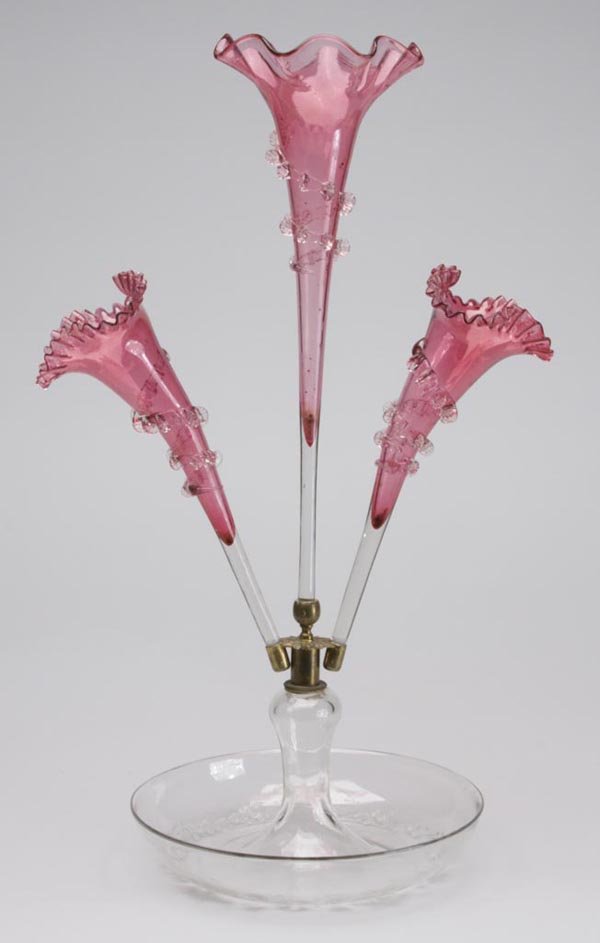 VICTORIAN GLASS THREE-VASE EPERGNE: VICTORIAN GLASS THREE-VASE EPERGNE, cased cranberry opalescent shading to colorless, vases with tooled or crimped rims, and applied rigaree, bowl with white enamel floral decoration. Late 19th/early 2