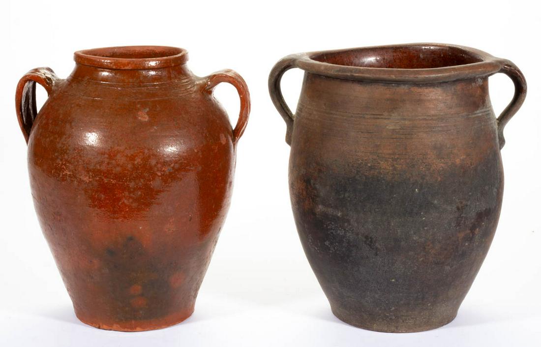 AMERICAN EARTHENWARE / REDWARE JARS, LOT OF TWO: AMERICAN EARTHENWARE / REDWARE JARS, LOT OF TWO, lead-glazed, each approximately two-gallons, ovoid form with incised shoulder rings and open strap handles. Mid 19th century. 12 3/4" HOA.Provenance: F