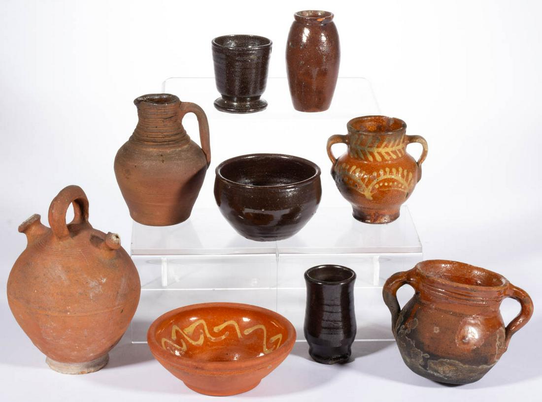 ASSORTED EARTHENWARE / REDWARE ARTICLES, LOT OF NINE: ASSORTED EARTHENWARE / REDWARE ARTICLES, LOT OF NINE, including an unglazed globular form harvest jug, two bud vases, one incised "JF" to underside, two examples with yellow slip decorations including