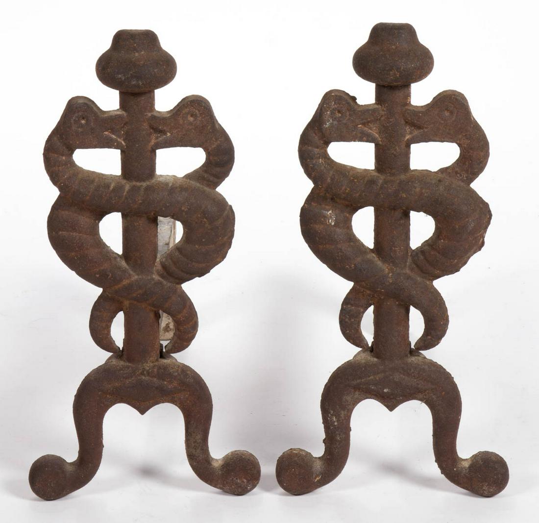 PAIR OF CAST-IRON FIGURAL CADUCEUS ANDIRONS: PAIR OF CAST-IRON FIGURAL CADUCEUS ANDIRONS, depicting the symbol of medicine, no markings located, with likely original log supports. First quarter 20th century. 17" H, 13 3/4" D. Provenance: Propert