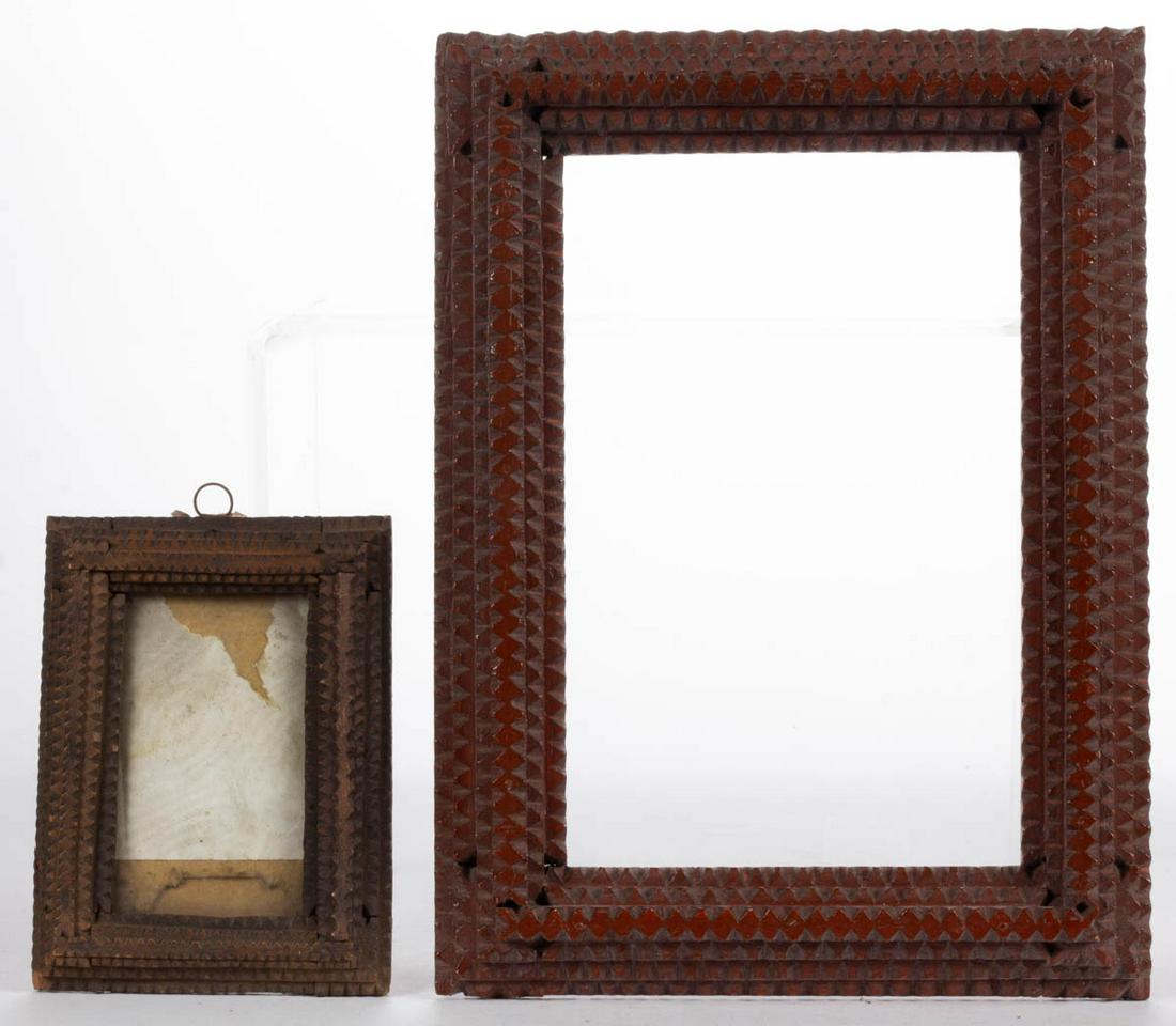 AMERICAN FOLK / TRAMP ART CARVED WOOD FRAMES, LOT OF: AMERICAN FOLK / TRAMP ART CARVED WOOD FRAMES, LOT OF TWO, each having layered and stepped chip-carved decoration, comprising a smaller walnut example with old surface, and a larger pine example with o