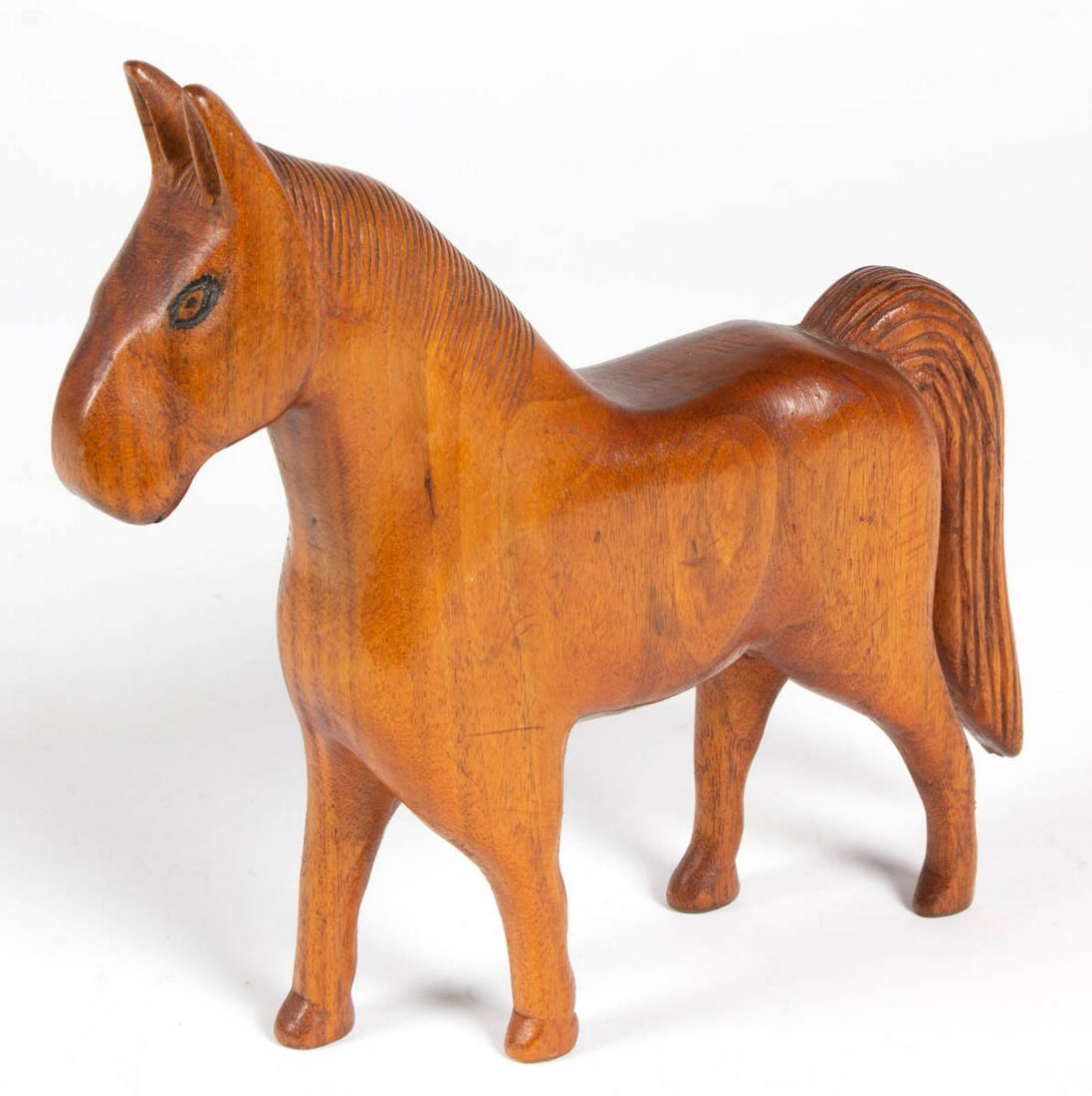 AMERICAN FOLK ART CARVED WALNUT FIGURAL HORSE: AMERICAN FOLK ART CARVED WALNUT FIGURAL HORSE, full body, with carved eyes. Old varnished surface with warm color. First half 20th century. 8 1/2" H, 9 1/4" L.
