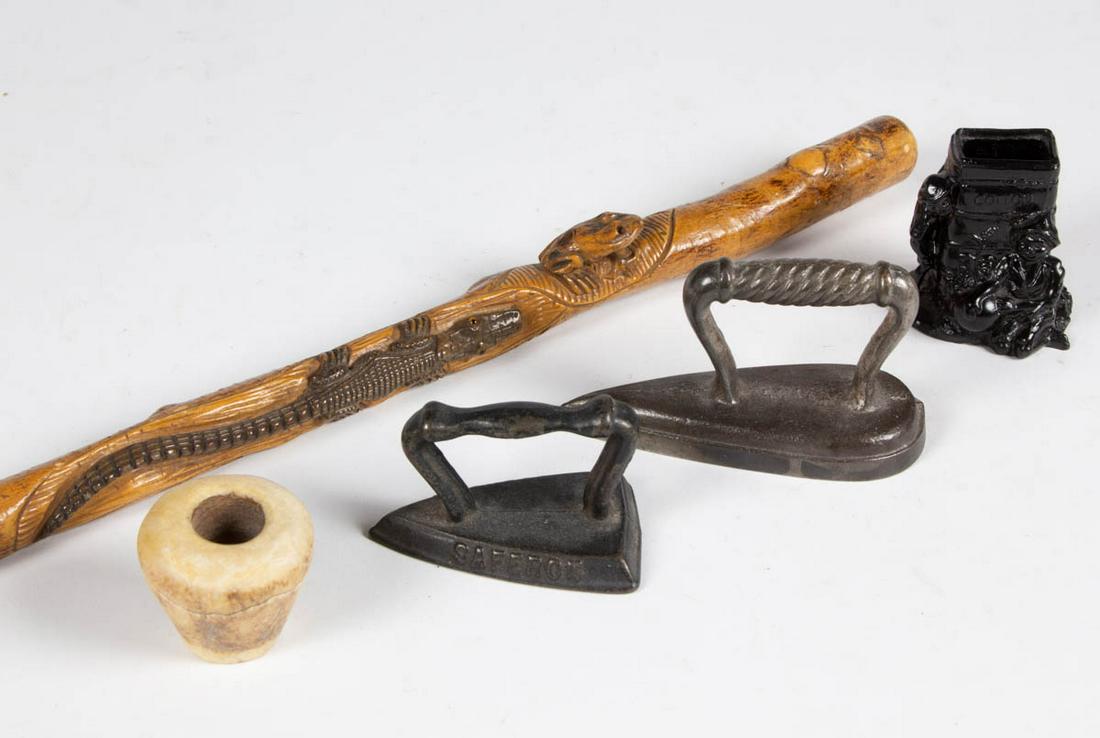 FOLK ART CARVED AND PAINTED FIGURAL WALKING STICK /: FOLK ART CARVED AND PAINTED FIGURAL WALKING STICK / CANE, featuring an alligator and a frog. Together with Black Americana toothpick holder, two sad irons, and a stone. Five pieces total. Late 19th/ea
