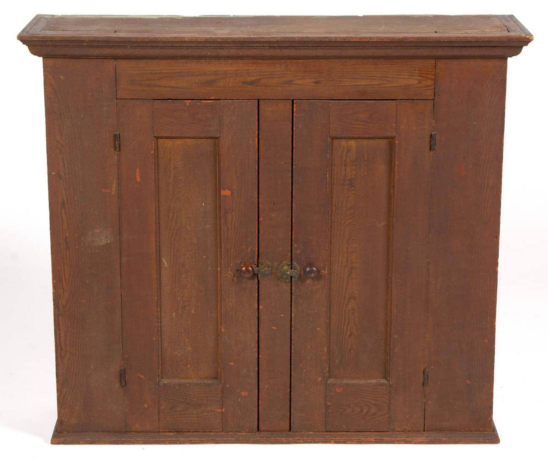 AMERICAN PAINT-DECORATED HANGING CUPBOARD: AMERICAN PAINT-DECORATED HANGING CUPBOARD, featuring applied cornice, over single hinged door concealing two shelves. Retains likely original paint-decorated surface. 19th century. 33 1/4" H, 38" W, 1