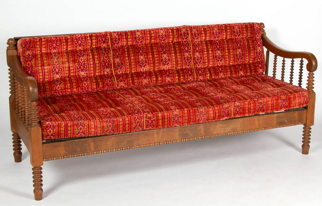 AMERICAN JENNY LIND WALNUT DAY BED / SOFA: AMERICAN JENNY LIND WALNUT DAY BED / SOFA, featuring elaborate turnings and shaped arm rails. Old surface with warm color. Fourth quarter 19th century. 33" H, 74" W, 28 3/4" D (closed). Provenance: Fr