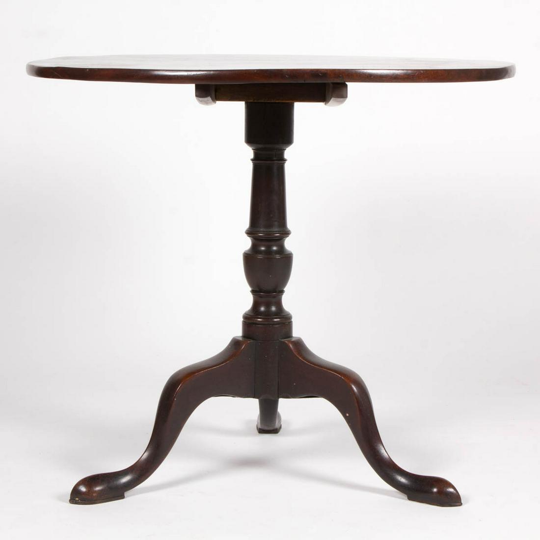 AMERICAN OR BRITISH MAHOGANY CHIPPENDALE TILT-TOP TEA: AMERICAN OR BRITISH MAHOGANY CHIPPENDALE TILT-TOP TEA TABLE, one-board circular top with battens affixed to the underside, ring-turned baluster pedestal, raised on tripod base of cabriole legs termina