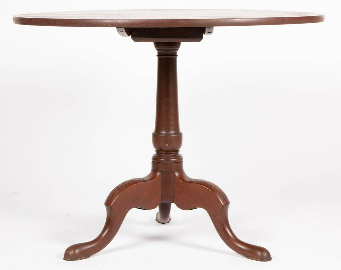 AMERICAN WALNUT TILT-TOP TEA TABLE: AMERICAN WALNUT TILT-TOP TEA TABLE, circular top with battens affixed to the underside, above baluster pedestal, raised on three cabriole legs with acanthus shell carvings, terminating in slipper feet