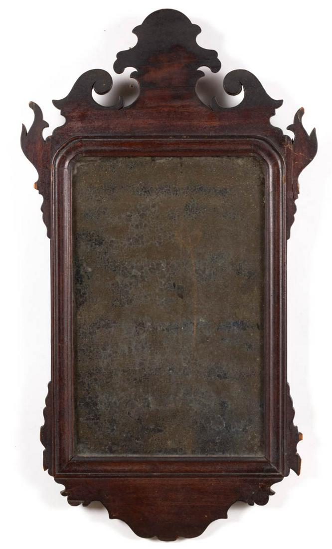 AMERICAN OR ENGLISH CHIPPENDALE MAHOGANY LOOKING GLASS: AMERICAN OR ENGLISH CHIPPENDALE MAHOGANY LOOKING GLASS / MIRROR, cut-out and scrolled work applied to a molded rectangular frame. Old surface with rich color. Late 18th/early 19th century. 24" HOA, 13