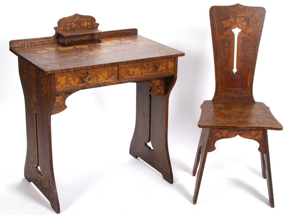 ARTS AND CRAFTS PYROGRAPHIC-DECORATED DESK AND CHAIR: ARTS AND CRAFTS PYROGRAPHIC-DECORATED DESK AND CHAIR, each featuring grapes and vines throughout. Original surface with warm color. Late 19th/early 20th century. Desk 35" HOA, 30" W, 19 3/4" D. Chair 