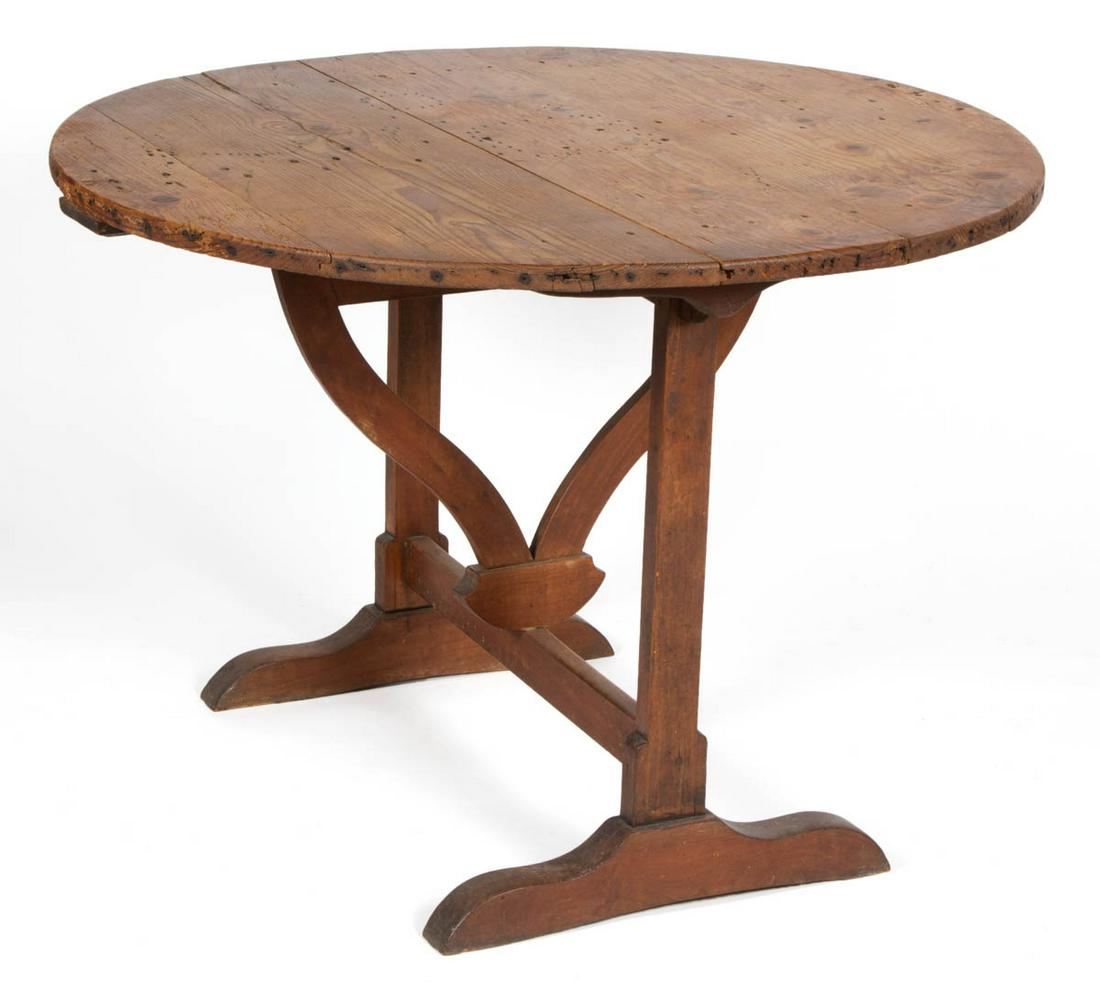 BRITISH PINE BUTTERFLY TABLE: BRITISH PINE BUTTERFLY TABLE, circular scrubbed top over rotating base raised on shoe feet. Oak secondary wood. Base with an old surface with mellow color. 19th century. 27" H, 38 1/2" D top. Provenan