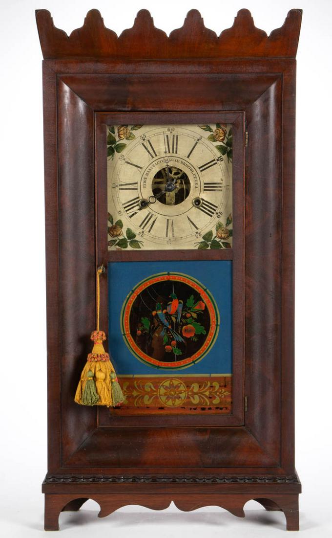 NEW ENGLAND MAHOGANY OGEE CASE SHELF CLOCK: NEW ENGLAND MAHOGANY OGEE CASE SHELF CLOCK, brass 30-hour works, painted and transfer-decorated wood face, lettered "UNION MANUFACTURING CO. BRISTOL, CT. U.S.A.", with central opening exposing the wor