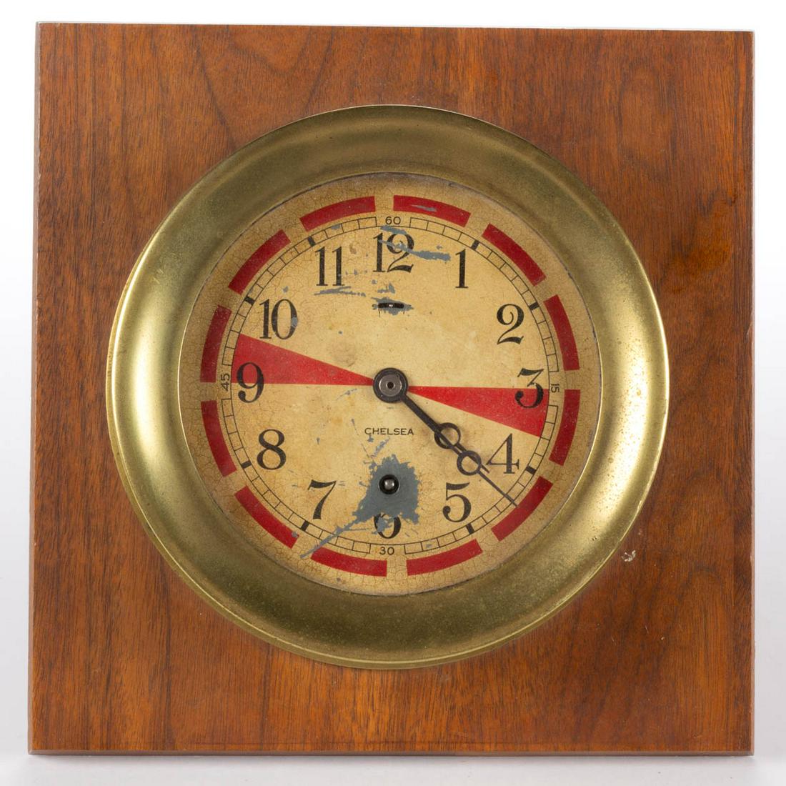 CHELSEA BRASS WORLD WAR II ERA SHIP'S RADIO ROOM CLOCK: CHELSEA BRASS WORLD WAR II ERA SHIP'S RADIO ROOM CLOCK, currently mounted on a wooden base. Circa 1940. 2 1/2" H, 7" D, 9 3/4" SQ base. Provenance: From the collection of Pat and Jerry Meyer, Silver S