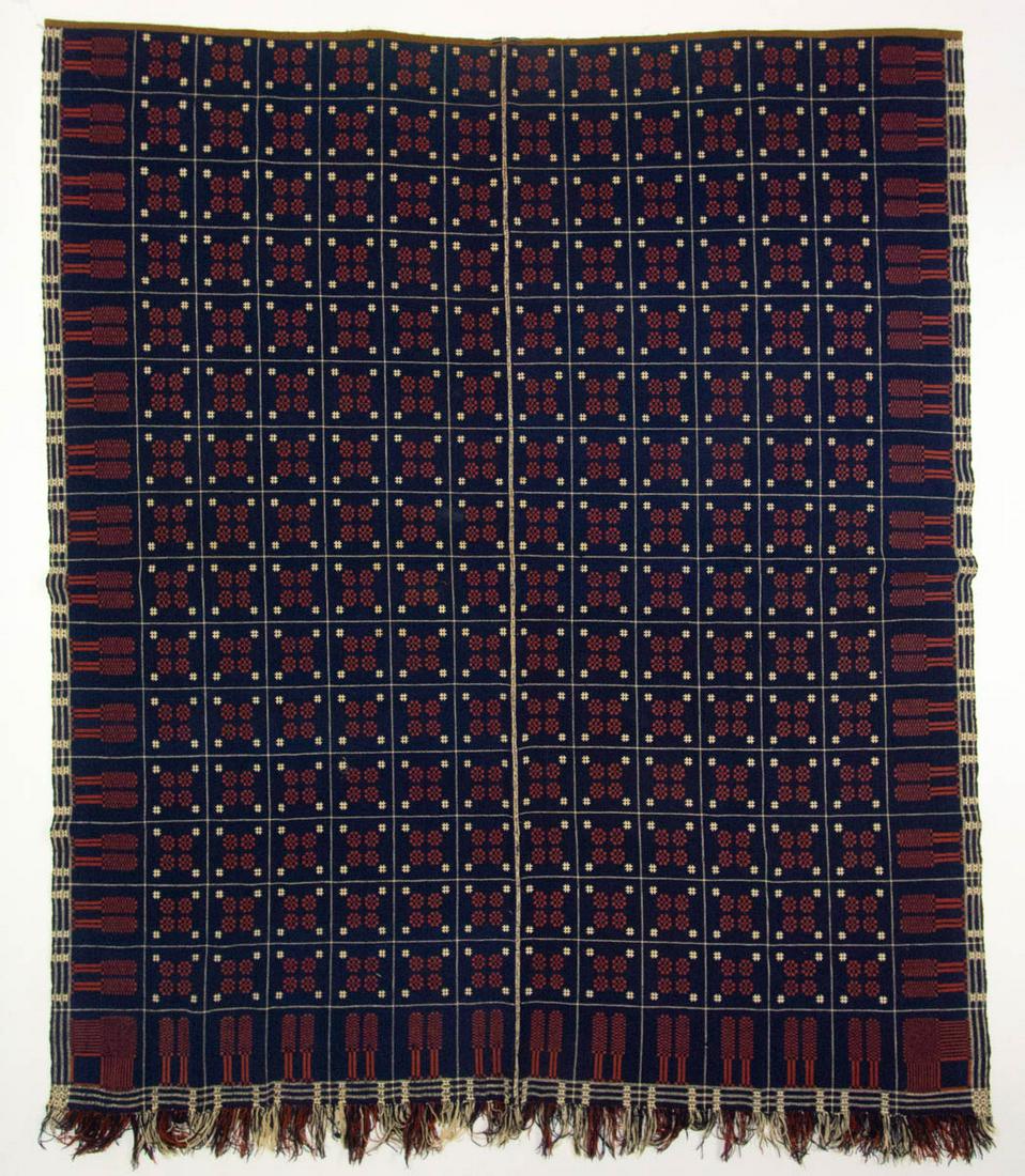 AMERICAN "SNOWBALL AND PINE TREE" DOUBLE-WEAVE COVERLET: AMERICAN "SNOWBALL AND PINE TREE" DOUBLE-WEAVE COVERLET, dark blue and rust red wool, and natural cotton, two joined panels, center field with snowball pattern arranged in a grid, three sides with pin