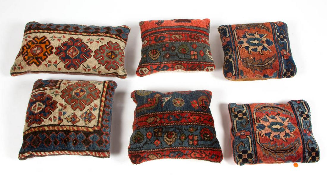 ORIENTAL / PERSIAN RUG FRAGMENT PILLOWS, LOT OF SIX: ORIENTAL / PERSIAN RUG FRAGMENT PILLOWS, LOT OF SIX, comprising two sets and two pillows with similar designs, each having geometric and floral motifs. 20th century. Longest pillow 20" x 10 1/2". Prov