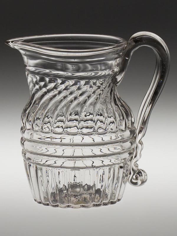 BLOWN-MOLDED GI-27 QUART PITCHER: BLOWN-MOLDED GI-27 QUART PITCHER, colorless, strongly patterned decanter-form body with a tooled and folded rim and a pinched and pulled spout, applied strap-style handle with a bold medial rib and pr
