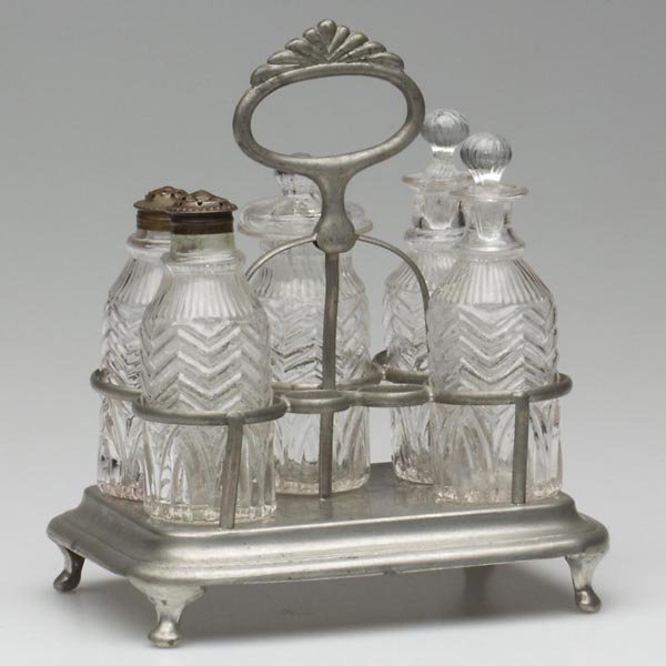 BLOWN-MOLDED GIV-4 FIVE-BOTTLE CASTER SET: BLOWN-MOLDED GIV-4 FIVE-BOTTLE CASTER SET, colorless, comprised of two cruets with appropriate ribbed-ball stoppers, two shakers with period copper caps, and a mustard pot with correct pattern-ribbed 