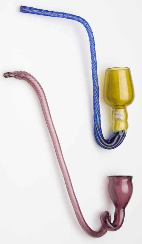 TWO FREE-BLOWN SMOKING PIPE WHIMSIES: TWO FREE-BLOWN SMOKING PIPE WHIMSIES, comprised of an amethyst example molded with delicate ribs, and a honey amber and sapphire blue example with twisted ribs. Probably United States. 1880-1920. Leng