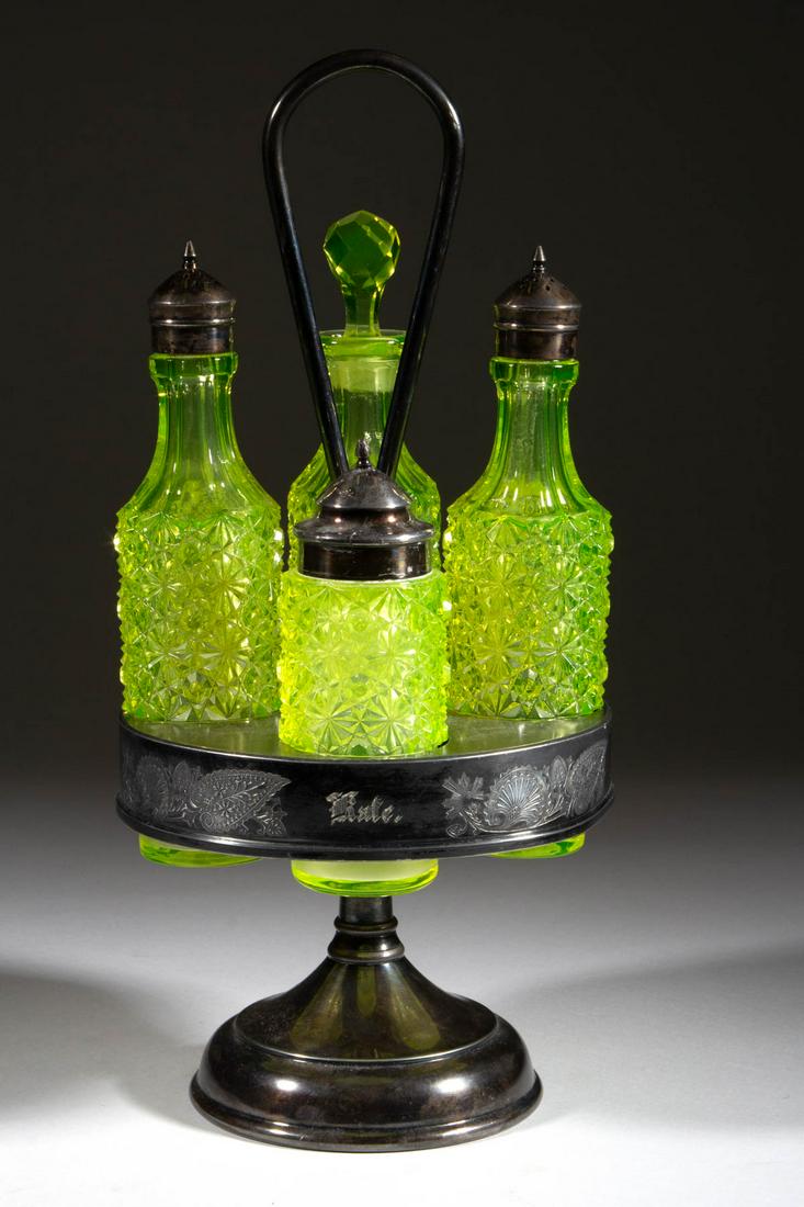 DAISY AND BUTTON FOUR-BOTTLE CASTER SET: DAISY AND BUTTON FOUR-BOTTLE CASTER SET, Vaseline (reacts under black light), comprising a oil bottle with period cut-faceted stopper, a salt and pepper shaker with period quadruple-plate lids, and a 
