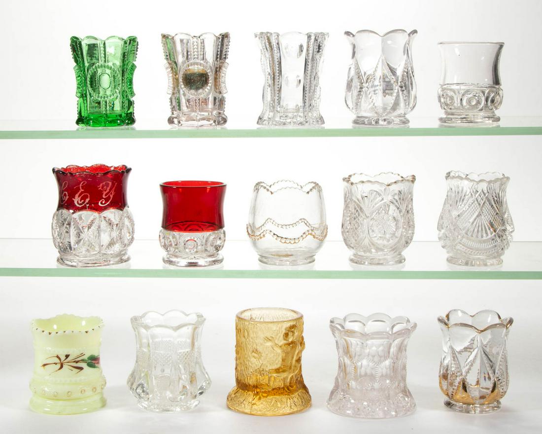 ASSORTED EAPG TOOTHPICK HOLDERS, LOT OF 15: ASSORTED EAPG TOOTHPICK HOLDERS, LOT OF 15, colorless, amber, green, and custard, including a Sunk Daisy, two Co-Op Royal, a Summit, and a Union's Radiant. Various makers. Fourth quarter 19th/first qu