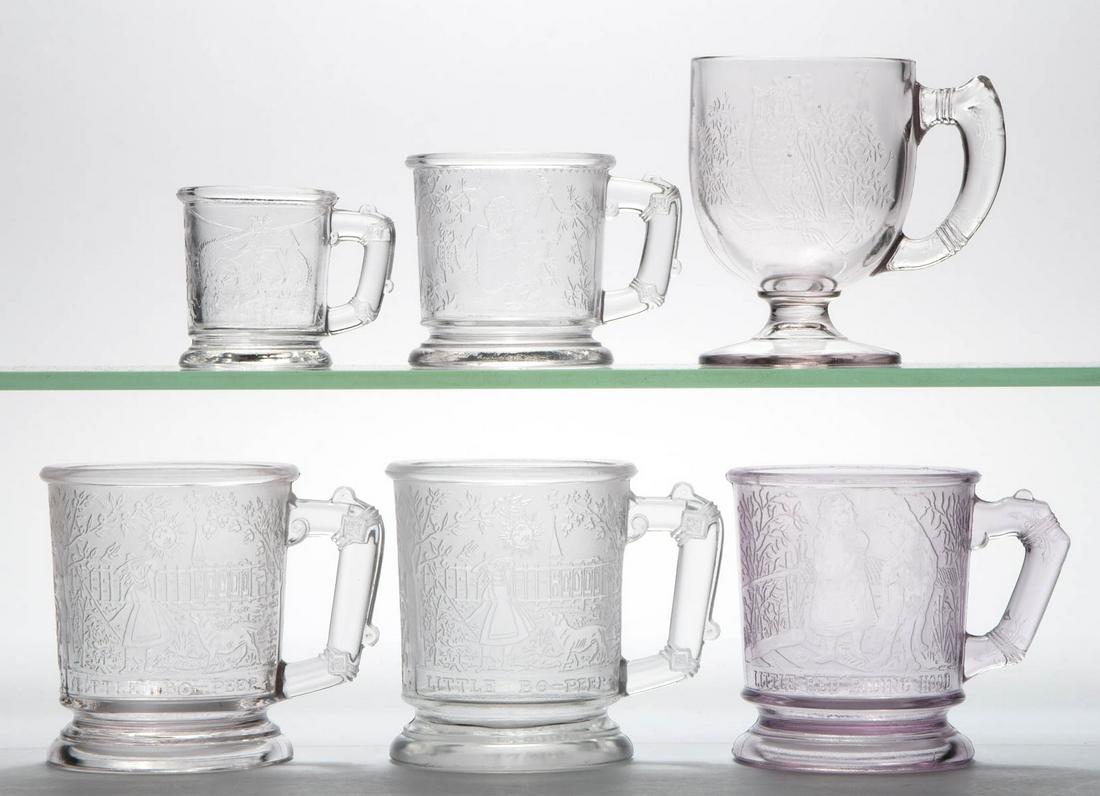 ASSORTED PRESSED CRYSTALLOGRAPHY GLASS MUGS, LOT OF: ASSORTED PRESSED CRYSTALLOGRAPHY GLASS MUGS, LOT OF FIVE, colorless, including a "LITTLE RED RIDING HOOD", two "LITTLE BO PEEP", and a fighting cats. Various makers. Fourth quarter 19th/first quarter 