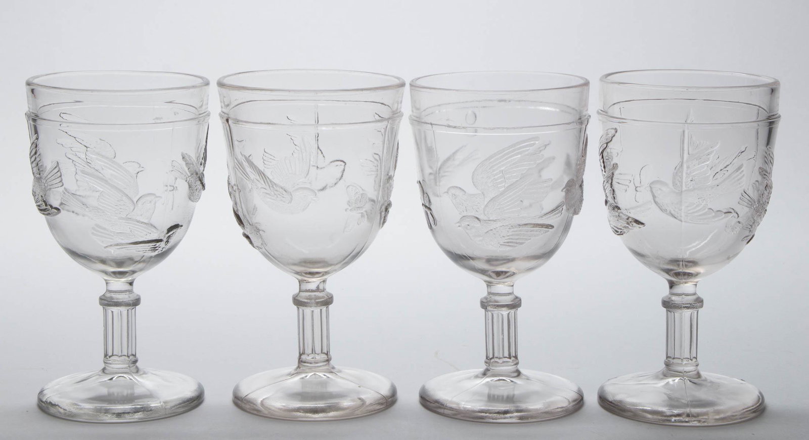 FLYING BIRDS GOBLETS, SET OF FOUR: FLYING BIRDS GOBLETS, SET OF FOUR, colorless. Fourth quarter 19th century. One 5 3/4" H, 3 1/8" D rim, 2 7/8" D foot. Provenance: From a Pennsylvania private collection.