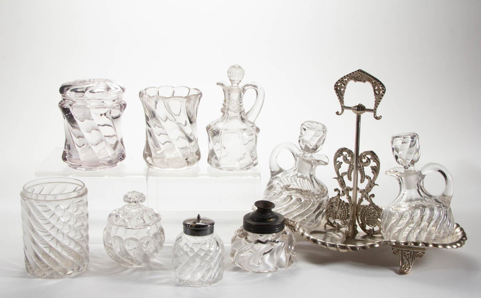 FOSTORIA NO. 112 / CASCADE (OMN) ARTICLES, LOT OF TEN: FOSTORIA NO. 112 / CASCADE (OMN) ARTICLES, LOT OF TEN, colorless, including three cruets with two having a matching pattern stoppers and fitted into a silver-plate stand, a mustard pot, an inkwell wit