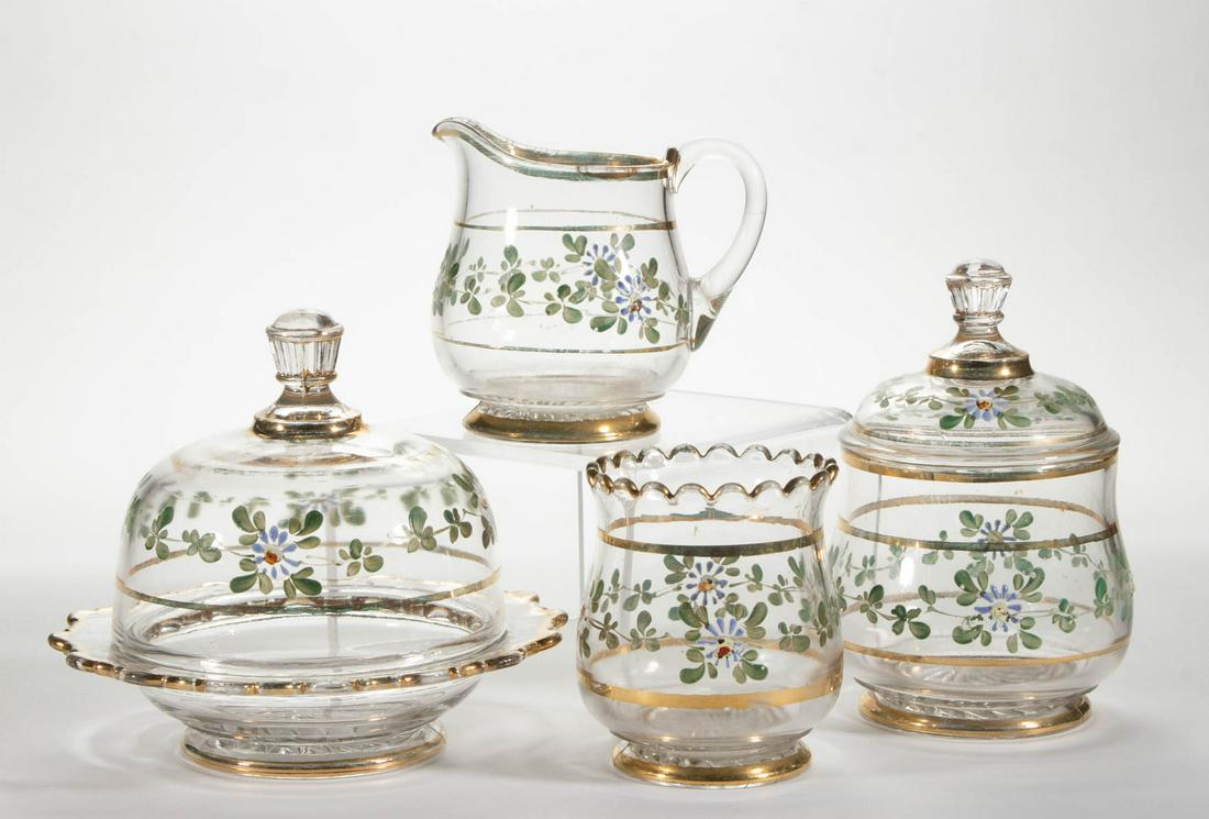 MADOLINE (OMN) FOUR-PIECE TABLE SET: MADOLINE (OMN) FOUR-PIECE TABLE SET, colorless with enamel and gilt decoration, comprising a covered butter dish, covered sugar bowl, creamer, and spooner. Co-Operative Flint Glass Co. Circa 1893. 4 1