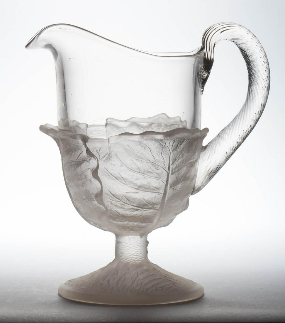 RIVERSIDE NO. 135 / CABBAGE LEAF WATER PITCHER: RIVERSIDE NO. 135 / CABBAGE LEAF WATER PITCHER, frosted colorless, applied swirled handle. Riverside Glass Works. Circa 1883. 10" H. Provenance: From the Briggs - Richardson Collection, Stephens City,