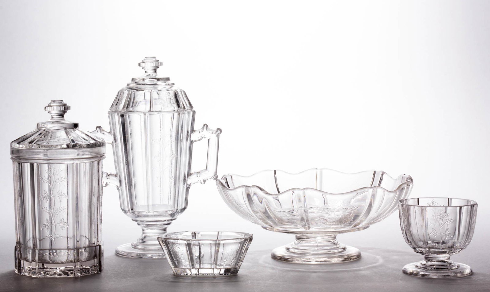 SPRIG / RIVAL (OMN) TABLE ARTICLES, LOT OF FIVE: SPRIG / RIVAL (OMN) TABLE ARTICLES, LOT OF FIVE, colorless, comprising a marmalade/jam jar, a pickle jar, a master salt, oblong salt, and a footed bowl with a manipulated rim. Bryce, Higbee & Co. Patt