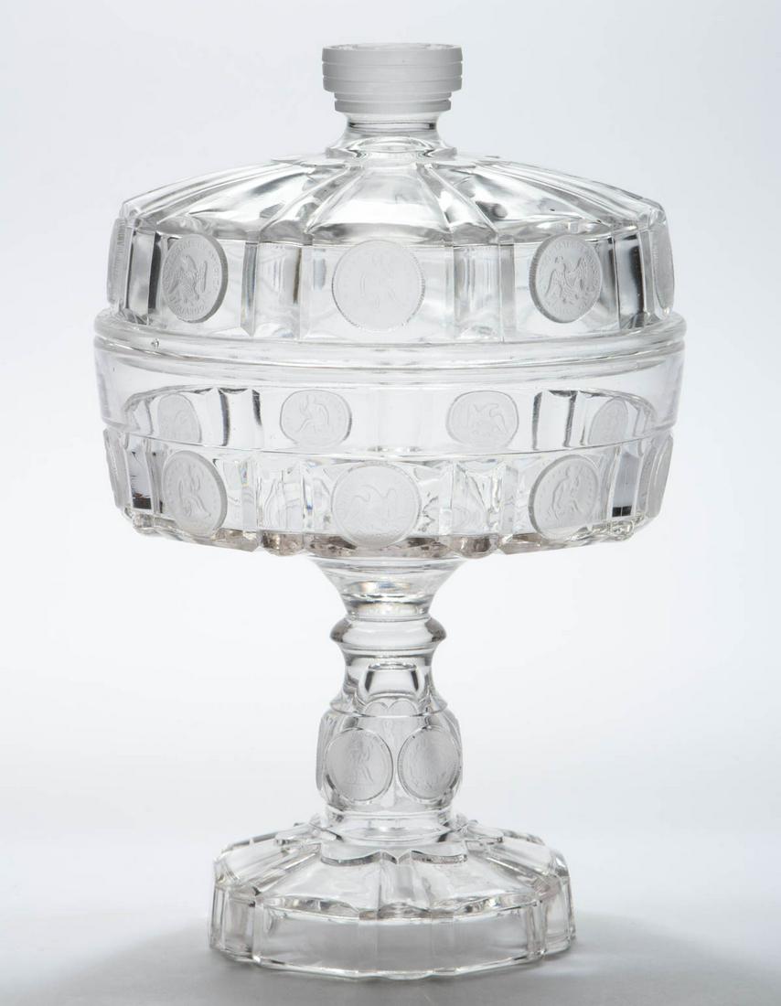 U. S. COIN / SILVER AGE (OMN) NO. 18 COVERED COMPOTE: U. S. COIN / SILVER AGE (OMN) NO. 18 COVERED COMPOTE, colorless with frosted coins, high standard with a dollar finial, quarter-dollars surrounding the bowl, and dimes on the stems. Central Glass Co. 