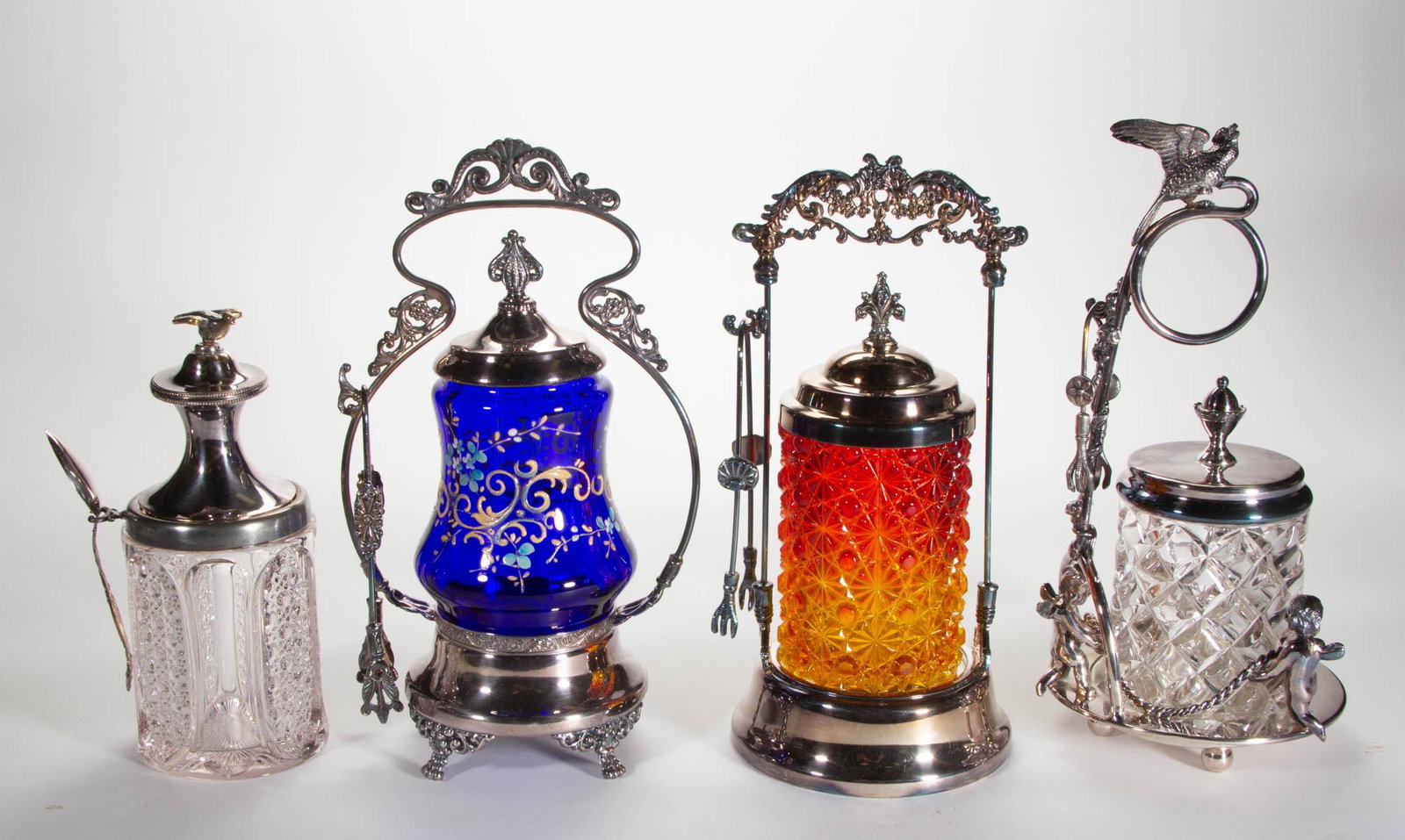 ASSORTED PRESSED AND BLOWN GLASS PICKLE CASTERS, LOT OF: ASSORTED PRESSED AND BLOWN GLASS PICKLE CASTERS, LOT OF FOUR, various colors, including an amberina Daisy and Button L. G. Wright example, a Panel-Optic with polychrome-enamel decoration, and a Pillow