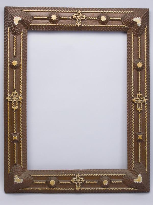 TRAMP ART CARVED PICTURE FRAME: TRAMP ART CARVED PICTURE FRAME, applied hearts, crosses and stars, paint possibly later. 20th century. 25 1/2" x 20 1/4" overall, 20" x 14 3/4" image seat.