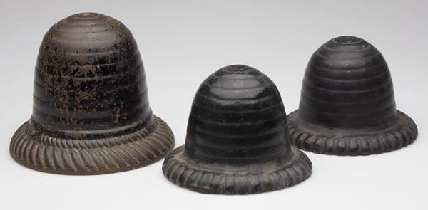 THREE CAST-IRON COUNTRY STORE FIGURAL STRING HOLDE: THREE CAST-IRON COUNTRY STORE FIGURAL STRING HOLDERS, each in the form of a beehive, one with under-base plate, original paint. Second half 19th century or early 20th century. 4 1/4" to 6 1/2" h. Prov