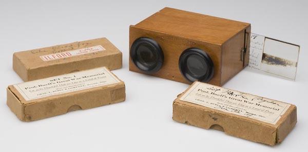UNIS FRANCE STEREOSCOPE AND GLASS SLIDES: UNIS FRANCE STEREOSCOPE AND GLASS SLIDES, viewer stamped on front, along with three boxes of WWI and Woodrow Wilson related glass slides. First half 20th century. Case 2" x 4 1/2", slides 1 3/4" x 4".