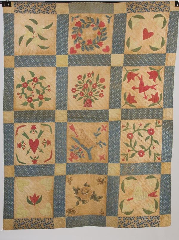 IMPORTANT SHENANDOAH VALLEY APPLIQUÉD ALBUM CRIB Q: IMPORTANT SHENANDOAH VALLEY APPLIQUÉD ALBUM CRIB QUILT, comprised of 12 blocks, each featuring a different design including hearts, wreaths, potted flowers, tulips, a bird on branch, and cut-out chin