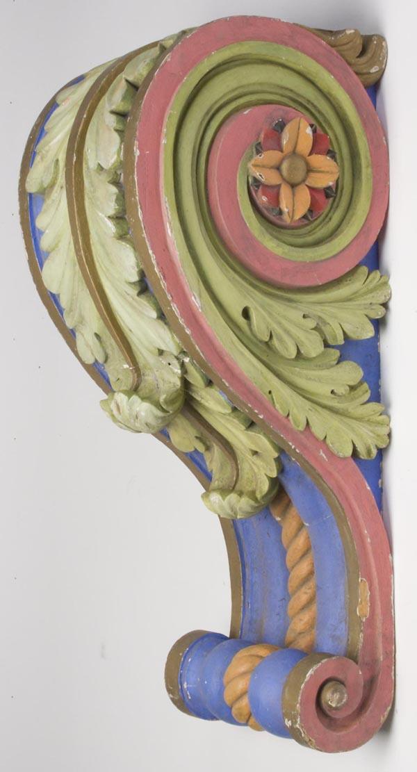 CARVED AND PAINTED ARCHITECTURAL CORBEL: CARVED AND PAINTED ARCHITECTURAL CORBEL, displaying scrolled acanthus leaf, rosette, and rope-like elements, polychrome paint, possibly off of a carousel. Early 20th century. 39" h, 13 1/2" w, 16" dee