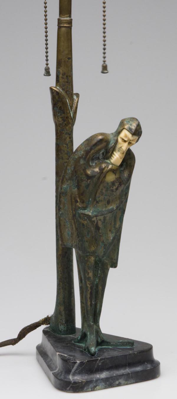 ROLAND PARIS (GERMAN, 1894-1945) BRONZE FIGURAL LA: ROLAND PARIS (GERMAN, 1894-1945) BRONZE FIGURAL LAMP, depicting a standing figure of Mephistopheles, carved ivory face and hands, raised on a black marble base signed "ROLAND PARIS" on edge, lotus-for