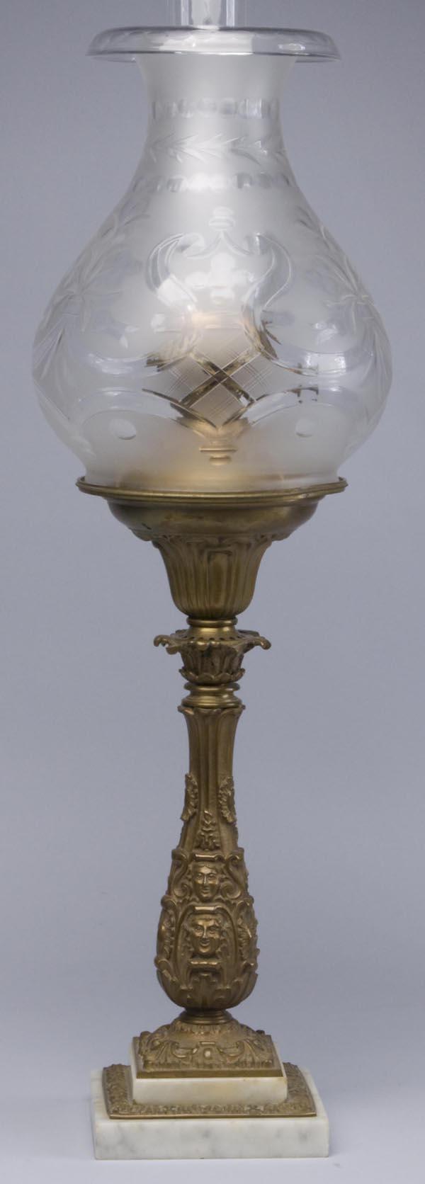 GILT-BRASS AND MARBLE SOLAR LAMP: GILT-BRASS AND MARBLE SOLAR LAMP, converted to kerosene, standard with masks, acanthus leaves, and shells, double-step base, original shade ring and excellent cut and frosted shade. Mid 19th century.