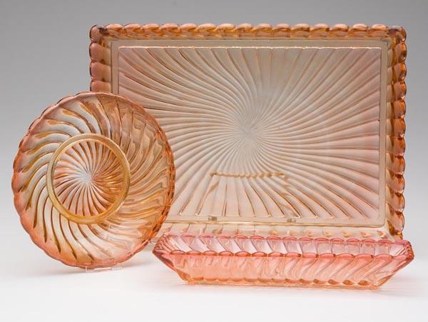 BACCARAT ROSE TEINTE SWIRL GLASS ARTICLES, LOT OF: BACCARAT ROSE TEINTE SWIRL GLASS ARTICLES, LOT OF THREE, consisting of a signed tray, a relish dish and a plate, each with polished table ring. First quarter 20th century. Tray 9 1/2" x 13". Provenanc